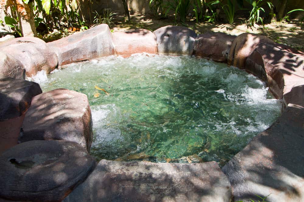 Blog hero photo for "Natural Stone Hot Tub Ideas in 2022" — relevant completed pool/backyard project