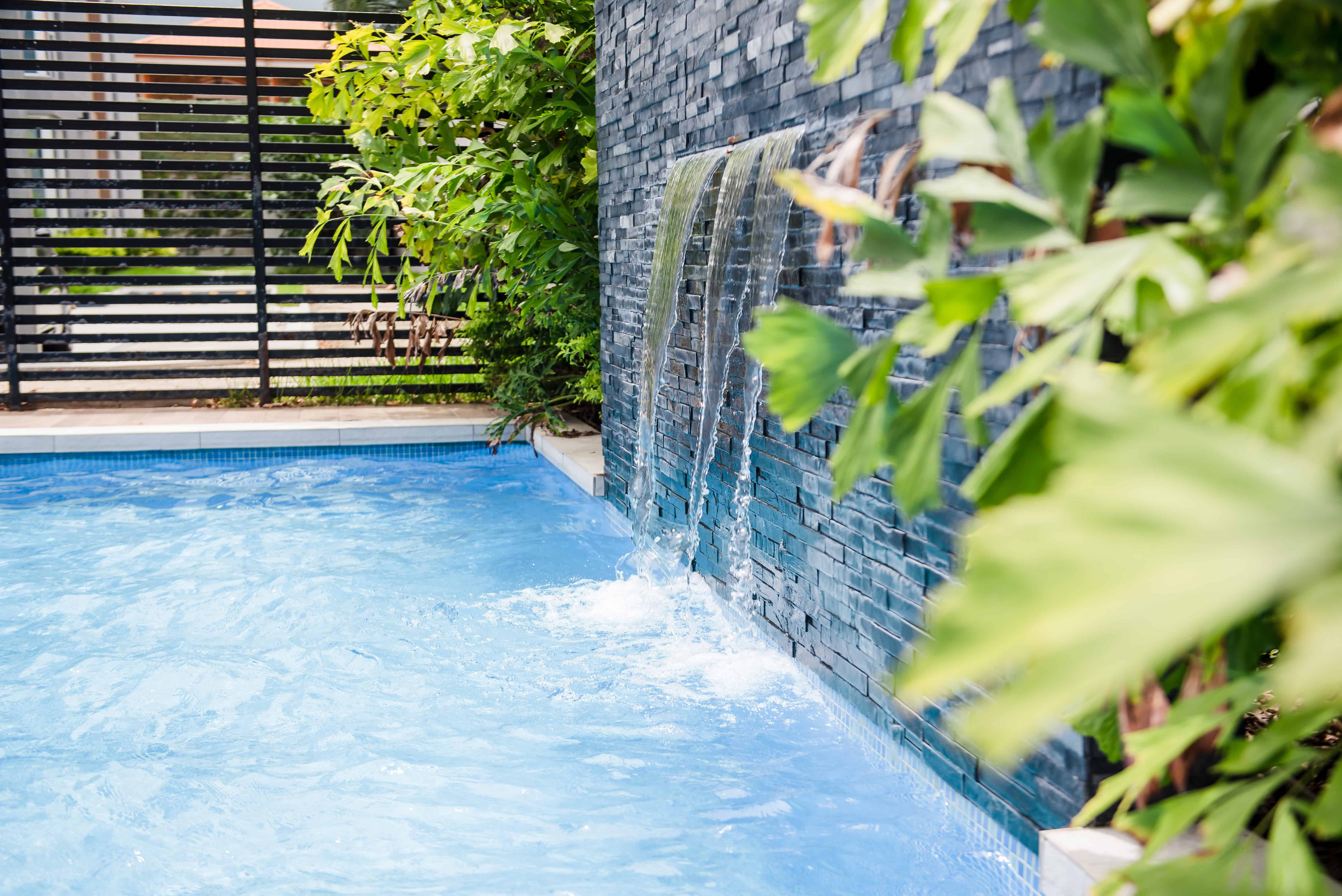 Blog hero photo for "Why Should You Add a Waterfall to Your Pool?" — relevant completed pool/backyard project